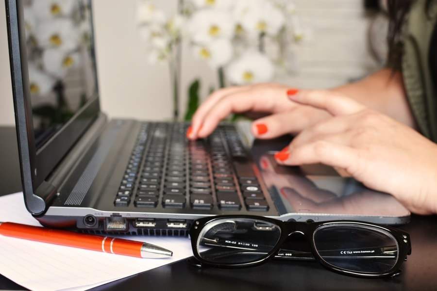 person woman desk laptop